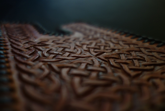 A closeup of a finished piece of Leathercraft with Celtic knotwork carved pattern